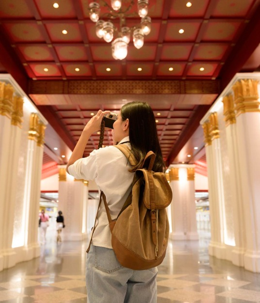 A happy traveler taking a photo in a beautiful location.